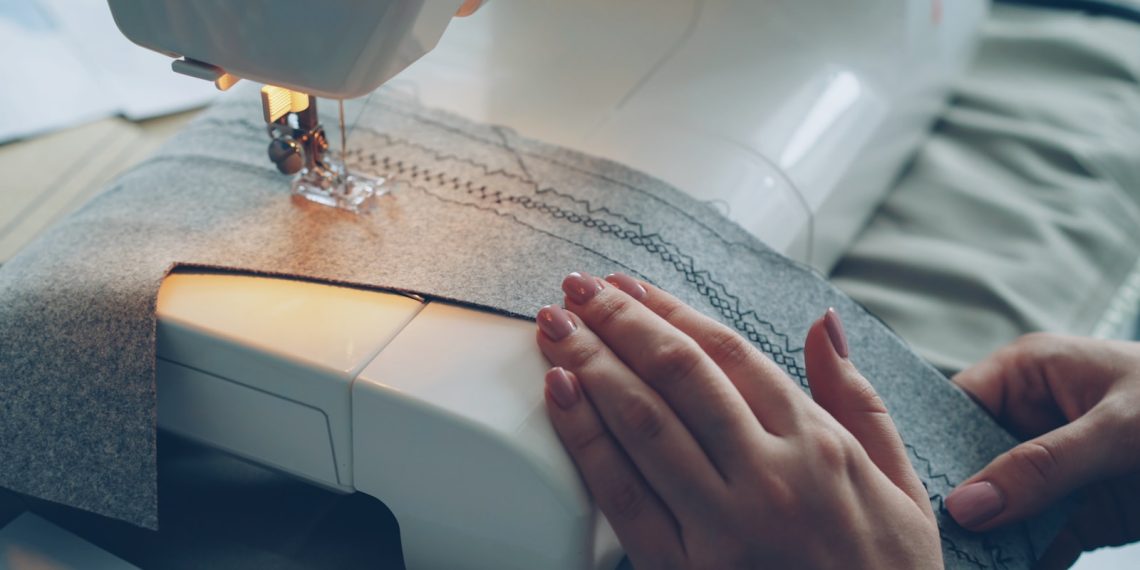 Someone is sewing with a sewing machine.