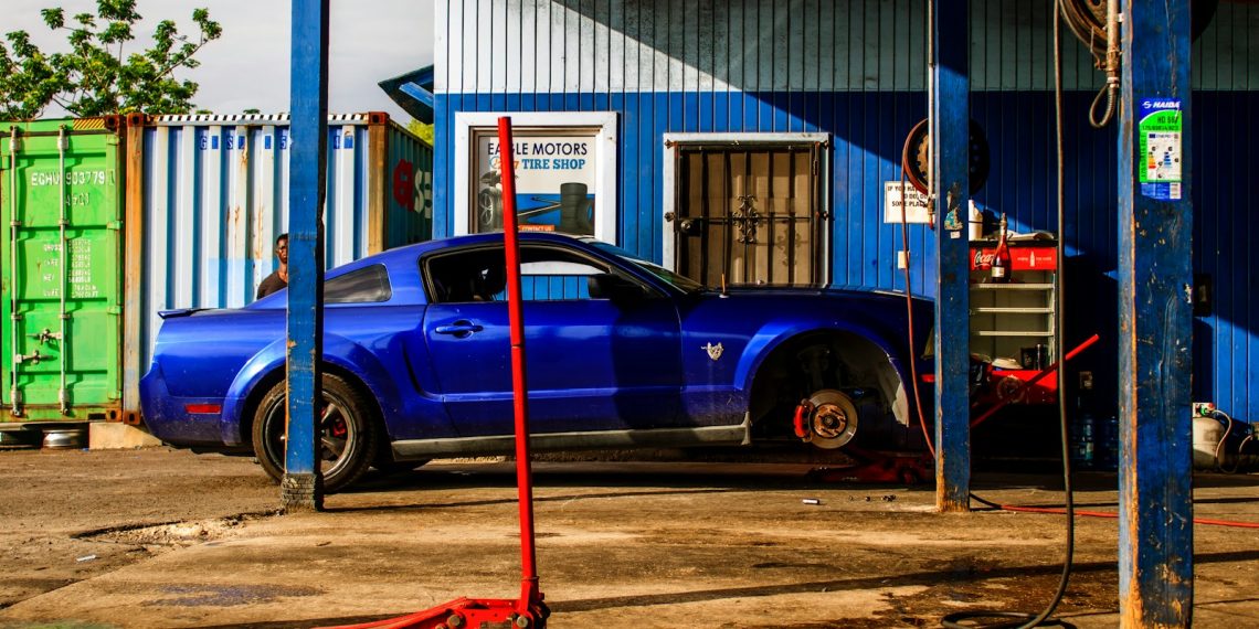 a blue car parked in front of a building
