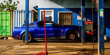 a blue car parked in front of a building