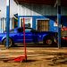 a blue car parked in front of a building